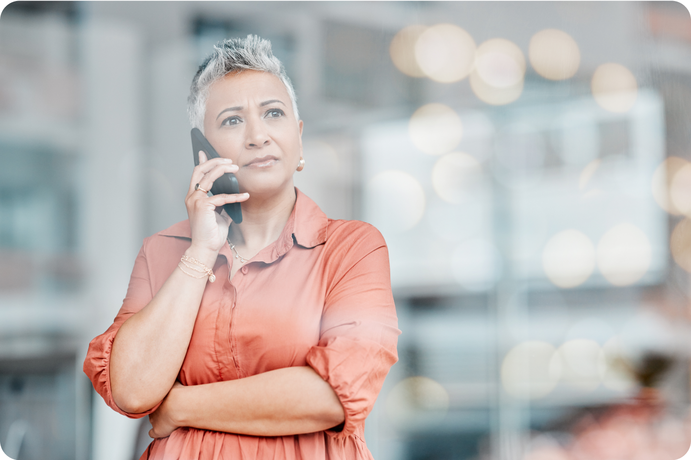 Photograph of a woman frowning while talking on the phone